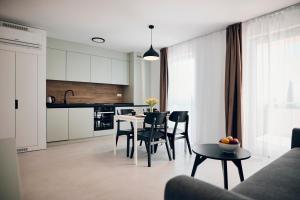 a kitchen and dining room with a table and chairs at Malinska Green Apartments in Malinska