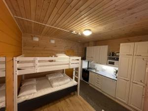 a small kitchen with a bunk bed in a room at Ylläs slope SarePiccolo in Ylläsjärvi