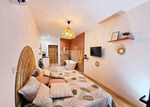 a room with a bed and a living room at Suite parentale avec parking in Albi