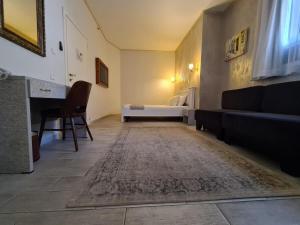 a living room with a bed and a couch at Hotel Alma - Near The Sea in Netanya