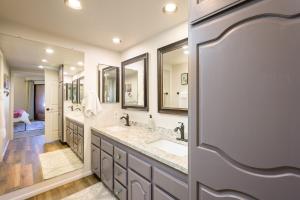 a bathroom with two sinks and two mirrors at Villa Anasazi condo in Phoenix