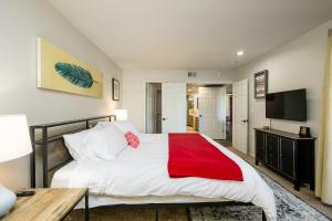 a bedroom with a large bed with a red blanket at Villa Anasazi condo in Phoenix