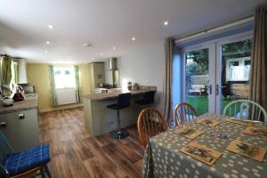 a kitchen and dining room with a table and chairs at The Old Wagon & Horses 19th Century Beer House in Glastonbury
