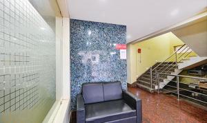 a waiting room with a chair in a building at FabHotel Triple Tree in Bhubaneshwar