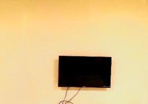 a flat screen tv hanging on a wall at Hotel Kewal INN Jalgaon in Jālgaon