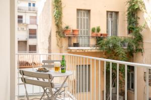 a table and chairs on the balcony of a building at Mooeve Exarchia in Athens