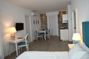 a living room with a couch and a table with chairs at Villa Quisisana Taormina in Taormina