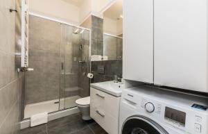 a bathroom with a shower and a washing machine at Rent like home - Gąsiorowskich 8 in Poznań