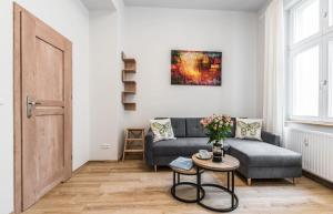 a living room with a couch and a table at Rent like home - Gąsiorowskich 8 in Poznań