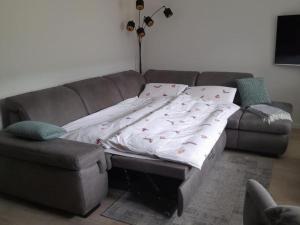 a couch with a blanket on it in a living room at Ferienwohnung Landradler in Bad Karlshafen