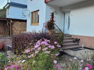 a house with a bunch of flowers in front of it at Ferienwohnung Landradler in Bad Karlshafen