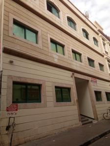 a tan building with a garage on the side of it at Dubai naif street Al nakhal in Dubai