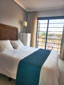 a bedroom with a bed with a view of a balcony at Modern Townhouse Ocean Front in Adeje +18 photos