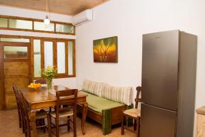 a living room with a table and a refrigerator at Traditional house in Fres in Karés