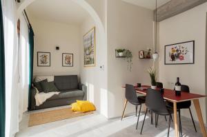 a living room with a table and a couch at Mooeve Exarchia in Athens