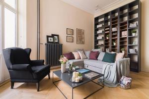 a living room with a couch and a chair at Rent like home - Hoża 39 in Warsaw
