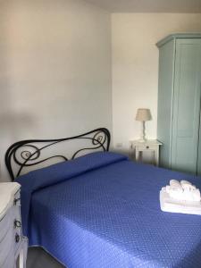 a bedroom with a blue bed with a blue blanket at Le Palmette in Monte Nai