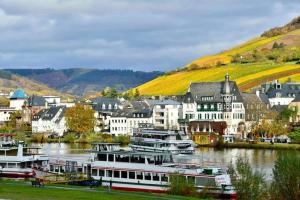 a town with boats docked in a river at Ferienhaus Take it easy in Traben-Trarbach