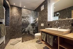 a bathroom with a sink and a toilet at Siplinger Suites - Ferienwohnungen - Sauna und Fitness in Balderschwang