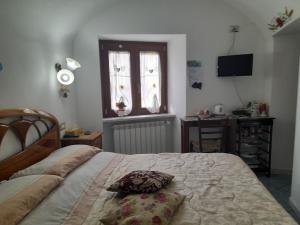 a bedroom with a bed with a pillow on it at Il Rifugio del Cuore in Agerola