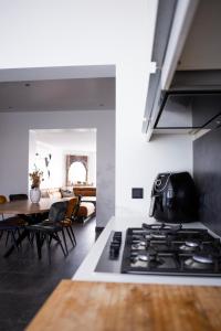a kitchen with a stove and a dining room at Luxurious House in Kerkrade Center in Kerkrade