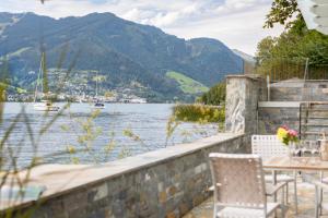 a patio with a view of a lake and mountains at Lakefront Suite 148 by we rent in Zell am See
