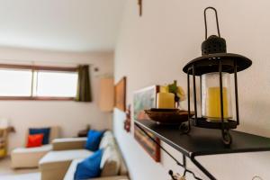 a living room with a light hanging from the wall at Casa Aprilia by Ca-Sa Check in Pellestrina