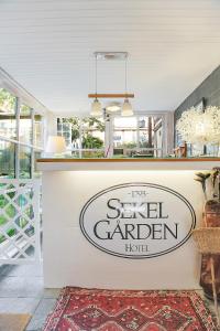 a restaurant with a sign for a small garden hotel at Anno 1793 Sekelgården in Ystad