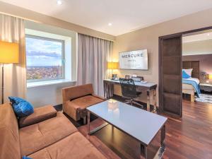 a living room with a couch and a table at Mercure Gdańsk Stare Miasto in Gdańsk