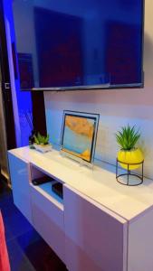 a white counter with a mirror and a plant on it at HOUSE 27 HABITAT in Lagos