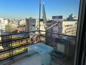a balcony with a table and a view of a city at Bucharest City Center Apartment in Bucharest