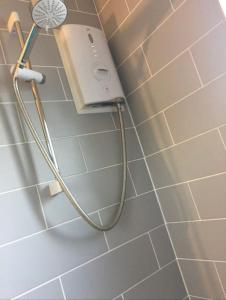 a shower head on the wall of a bathroom at Lovely 12th floor 2 bed flat in the heart ofLondon in London