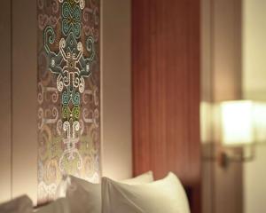a room with a bed with a cross on the wall at Grand Hyatt Jakarta in Jakarta