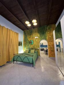 a bedroom with a green bed in a room at The Flower Garden in Castellammare di Stabia