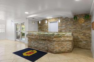 a bar in a room with a brick wall at Super 8 by Wyndham Harbison/Parkridge Hospital in Columbia