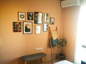 a corner of a room with pictures on the wall at Kalina Apartment Kazanlak in Kazanlŭk