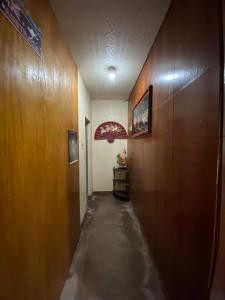 a hallway with a long corridor with wooden walls at Perucho-Silang Guest House in Mabini