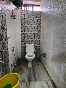 a bathroom with a toilet and a sink at AMIT HOTEL in Kolkata +4 photos