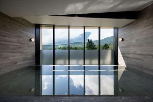 a room with a reflection of the sky in the water at Fuji Speedway Hotel - The Unbound Collection by Hyatt in Oyama