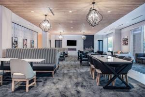a dining room with tables and chairs and lights at La Quinta Inn & Suites by Wyndham Yucaipa 