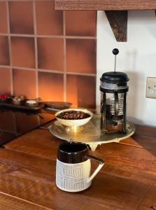 a coffee maker and a cup on a table at Spacious & Light Studio Loft in Alloa