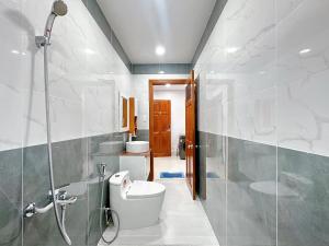 a bathroom with a toilet and a shower at Milanesa Hotel and Apartment in Vung Tau