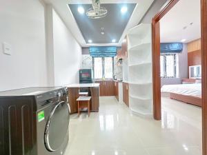 a bathroom with a washer and dryer in a room at Milanesa Hotel and Apartment in Vung Tau