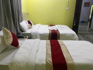 Voodi või voodid majutusasutuse Hotel Kavya Inn toas