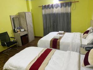 Voodi või voodid majutusasutuse Hotel Kavya Inn toas