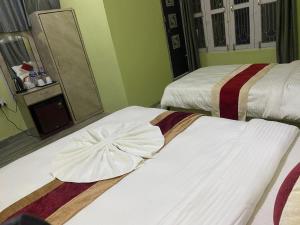 Voodi või voodid majutusasutuse Hotel Kavya Inn toas