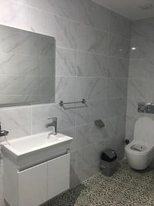 a bathroom with a sink and a toilet at Bella Casetta Guest House in Famagusta