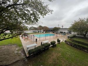 a swimming pool with benches in a park at Motel 6 Mesquite, TX Town East in Mesquite