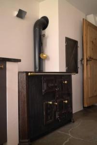 an old wood stove with a pipe in a room at Chesa Klucker - Fextal in Fex