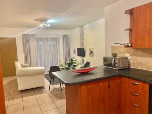 a kitchen with a counter top with a microwave at Mall of Africa View in Midrand
